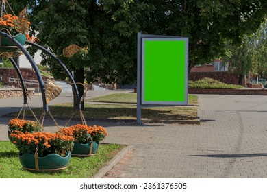 Green advertising billboard. street mockup panel. digital lightbox poster ad banner board. bus shelter advertising. green park background. vertical format sign. stucco facades. - Powered by Shutterstock