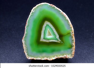 Green Agate Geode Stone Specimen, With Rings Of Different Green Shades, Against A Black Limbo Background