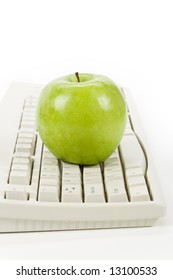 green apple and computer keyboard, concept of online learning