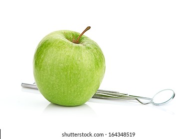 Green Apple And Dental Tools Isolated On White