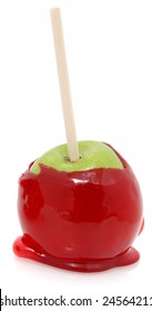 Green Apple Dipped In Red Candy Coating On A Stick.