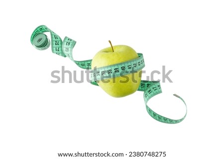 Green apple and measuring tape flying isolated on white background. Symbol of healthy dieting and control body weight. 
