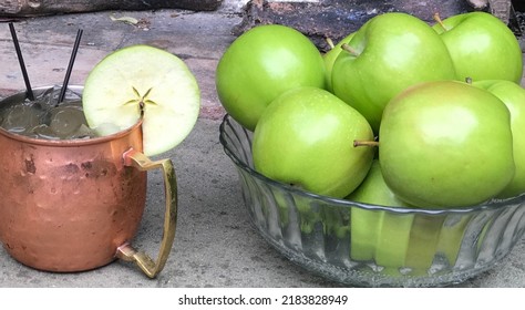 Green Apple Moscow Mule Cocktail With Bowl Of Apples.