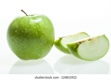 Green apple and slice on white background