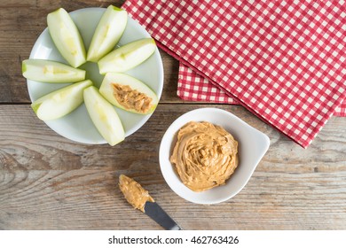 Green Apple Sliced With Peanut Butter And Fruit. Top View.