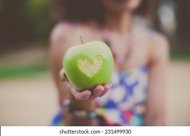 green apple in woman hands - Powered by Shutterstock