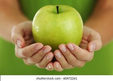 green apple in woman hands - Powered by Shutterstock