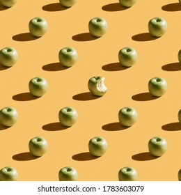 Green apples pattern on yellow background. Wallpaper pattern with apple. Fruit and food theme. Good for wallpaper, textile, background, poster.