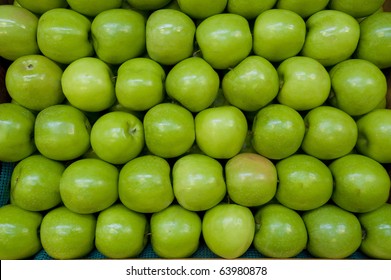 Green Apples Stacked Together On Farm Stand