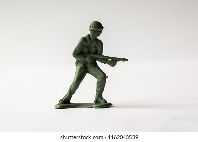 Green Army Men Toys Aginst A White Background