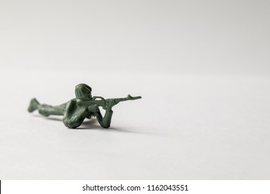 Green Army Men Toys Aginst A White Background