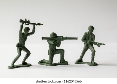 Green Army Men Toys Aginst A White Background