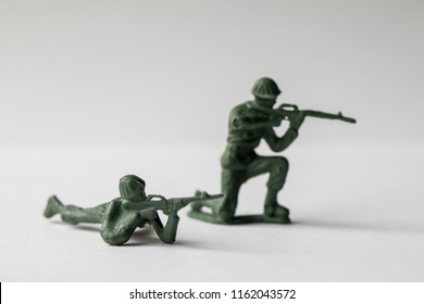 Green Army Men Toys Aginst A White Background