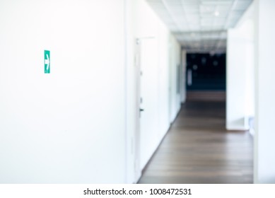 Green arrow pointer on the wall in the white hall.