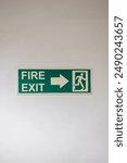 Green arrow with text Fire Exit. sign board showing emergency Fire exit icon. sign board showing direction towards fire exit in hotel, resort or office building. Signage pointing right 