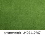 Green artificial grass as background, top view