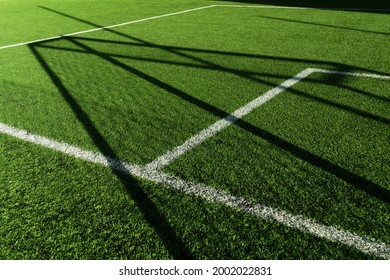 Green Artificial Grass Football Or Soccer Field With White Line And Goal Net Shadow Background	