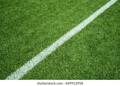 Green Artificial Grass Turf Field With White Line Boundary