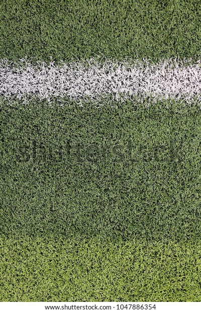 green artificial turf field with white paint\
border line with black rubber\
fills