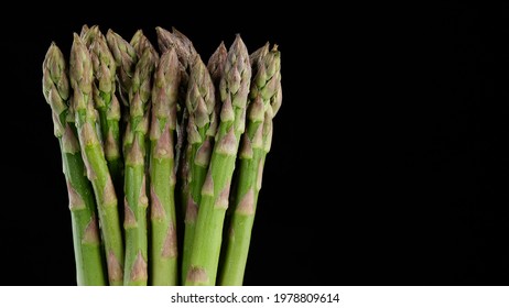 Green Asparagus Bunch Isolated On Black Background.