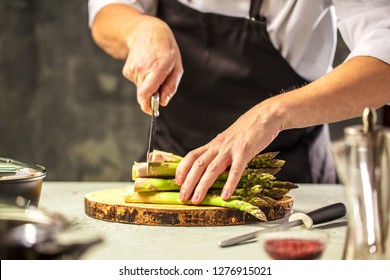 Green asparagus kept in men's Chef cook hands - Shutterstock ID 1276915021