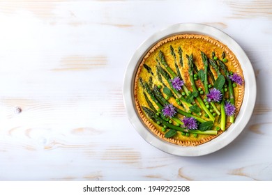 Green Asparagus, Sweet Peas Tart With Edible Chives Flowers Or Blossoms. Seasonal Spring Dinner, Overhead View. 