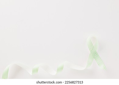 Green awareness ribbon of Gallbladder and Bile Duct Cancer month isolated on white background with copy space, concept of medical and health care support - Shutterstock ID 2256827313