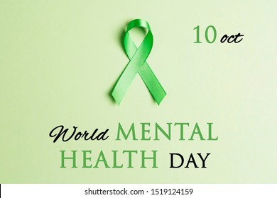 Green Awareness Ribbon On A Green Background. World Mental Health Day Concept. 