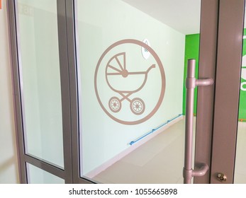 green baby carriage sign painted on scratched wooden board texture background