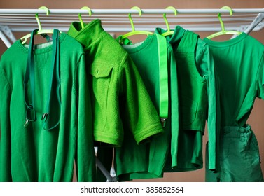 Green Baby Clothes On Hangers In The House