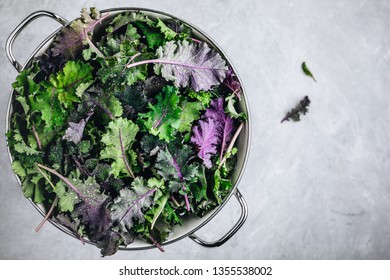 Green baby kale leaves in white colander on gray stone background. Ingredient for healthy vegetarian or vegan smoothie, salads or pesto sauce - Powered by Shutterstock