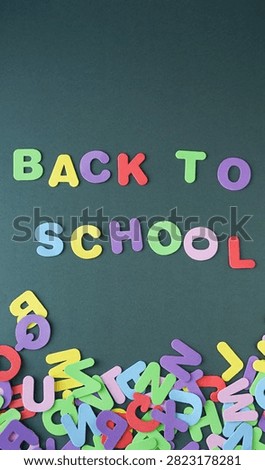 green background with the phrase back to school and some letters in disarray at the bottom