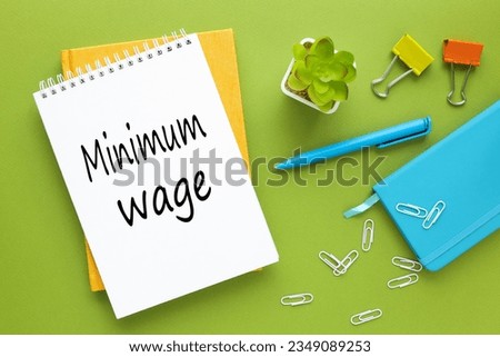 green background. sticker and glasses. business concept. bright stationery- minimum wage