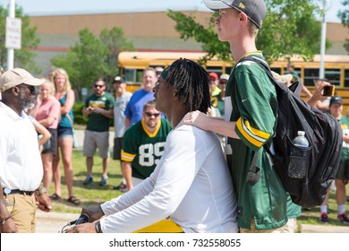 Green Bay, WI - August 1, 2017:  Green Bay Packer Davante Adams Rides A Young Fans Bike After Football Practice.  The Community Owned Team Has A Long Tradition Of Player Involvement With Fans.