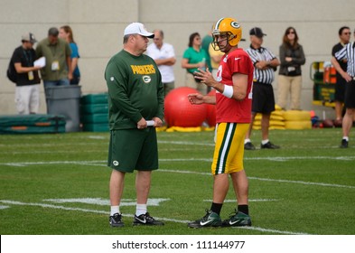 GREEN BAY, WI - AUGUST 19 : Green Bay Packers Quarterback Aaron Rodgers Talks With Head Coach Mike McCarthy During Training Camp Practice On August 19, 2012 In Green Bay, WI