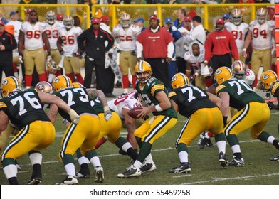 GREEN BAY, WI - NOVEMBER 22 : Green Bay Packers quarterback Aaron Rodgers takes the snap in a game at Lambeau Field against the San Francisco 49ers on November 22, 2009 in Green Bay, WI
