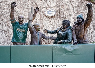 Green Bay, Wisconsin / USA - April 18th, 2020: Iron statues of fans celebrating a Green Bay Packers game at Lambeau field in Green Bay.  