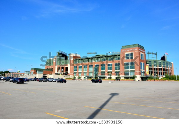 Green Bay, Wisconsin / USA July 7, 2018: Green Bay\
Packers Stadium on a warm summer morning with a few cars in the\
parking lot. 