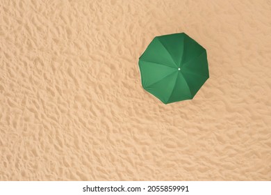 Green Beach Umbrella On Sandy Coast, Aerial View. Space For Text