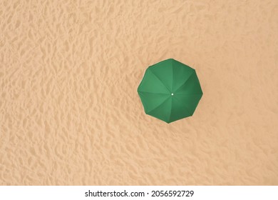 Green Beach Umbrella On Sandy Coast, Aerial View. Space For Text