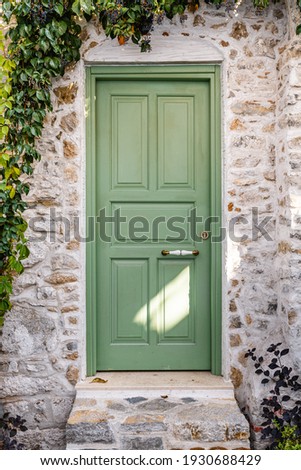 Green beautiful door in Marmaris Turkey. External wooden door and ivy on the wall