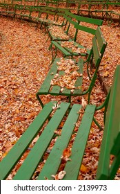 Green Benches In Autumn - The Green Benches At Seasongood Pavilion Are Empty And The Ground Surrounding Them Wears A Blanket Of Dried Leaves In Autumn. Eden Park, Cincinnati Ohio, USA