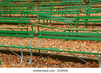 The Green Benches At Seasongood Pavilion Are Empty And One Bench Is Damaged As They Sit Among The Dried Leaves In Autumn. Eden Park, Cincinnati Ohio, USA