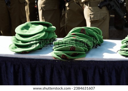 Green berets of the Nahal Brigade of the Israel Defense Forces stacked on a table during a special induction ceremony for new soldiers. 