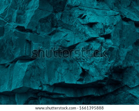  Green blue abstract grunge background. Toned rock texture. Texture of the mountains closeup. The combination of teal color and rough rocky shape. Volumetric stone background. 3D effect.             