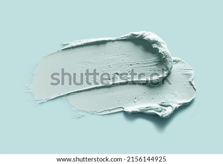 Green blue cosmetic mask sample isolated on mint color background