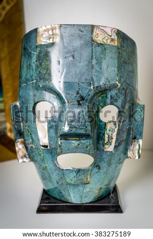 green and blue Mexican mask display