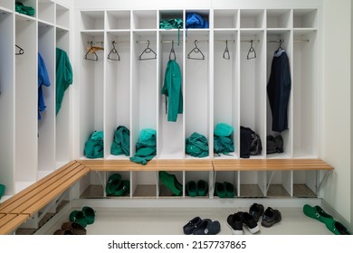 green and blue surgical gowns hang in an operating room in a hospital - Powered by Shutterstock