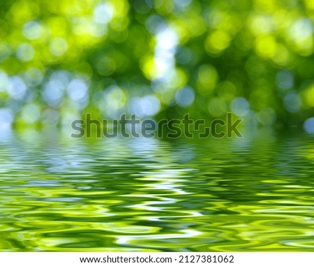 Green blur spring background with flood water efect