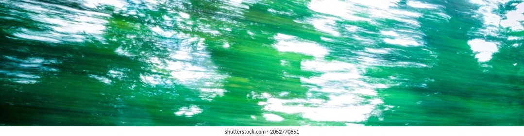 Green blurry trees leaves abstract background motion blur banner - Powered by Shutterstock